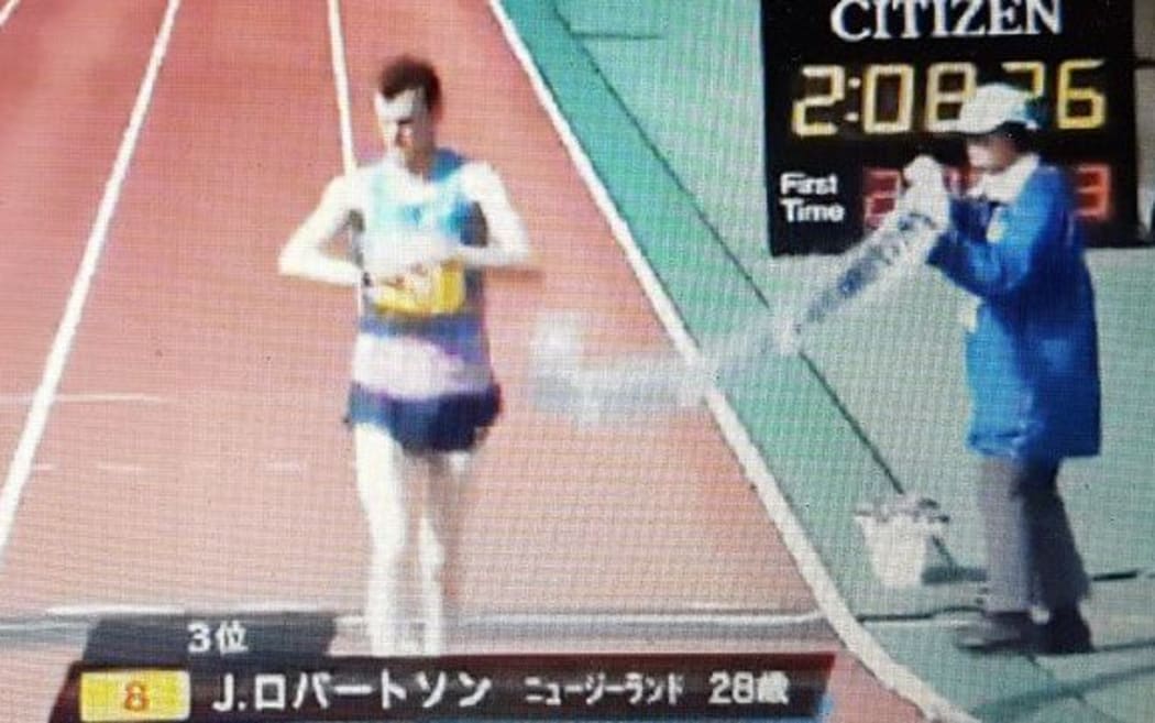 Jake Roberston crosses the finish line in Japan.