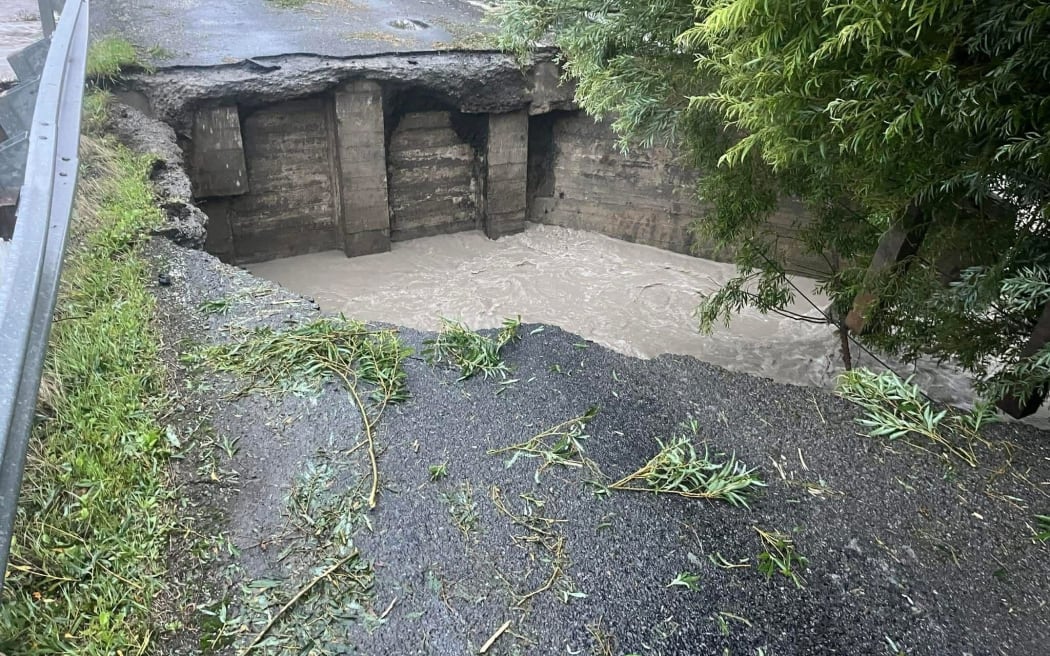 The single-lane bridge to Lake Ferry, Wairarapa, has been gouged out by floodwaters.