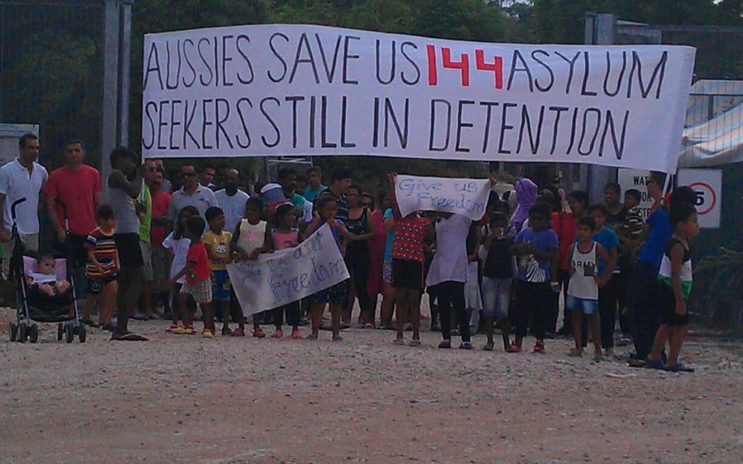 Protesters gather outside the family compound of the asylum seeker detention centre on Nauru.