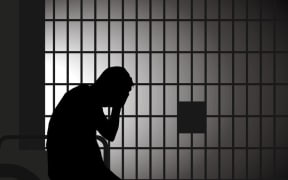Sad person in jail