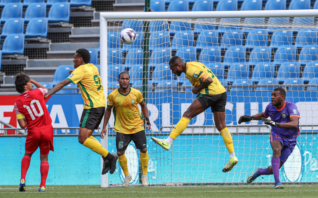 Brian Kaltack heads the ball while defending against Tahiti.