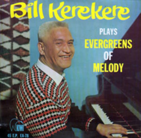 A smiling man in a striped sweater plas the piano.