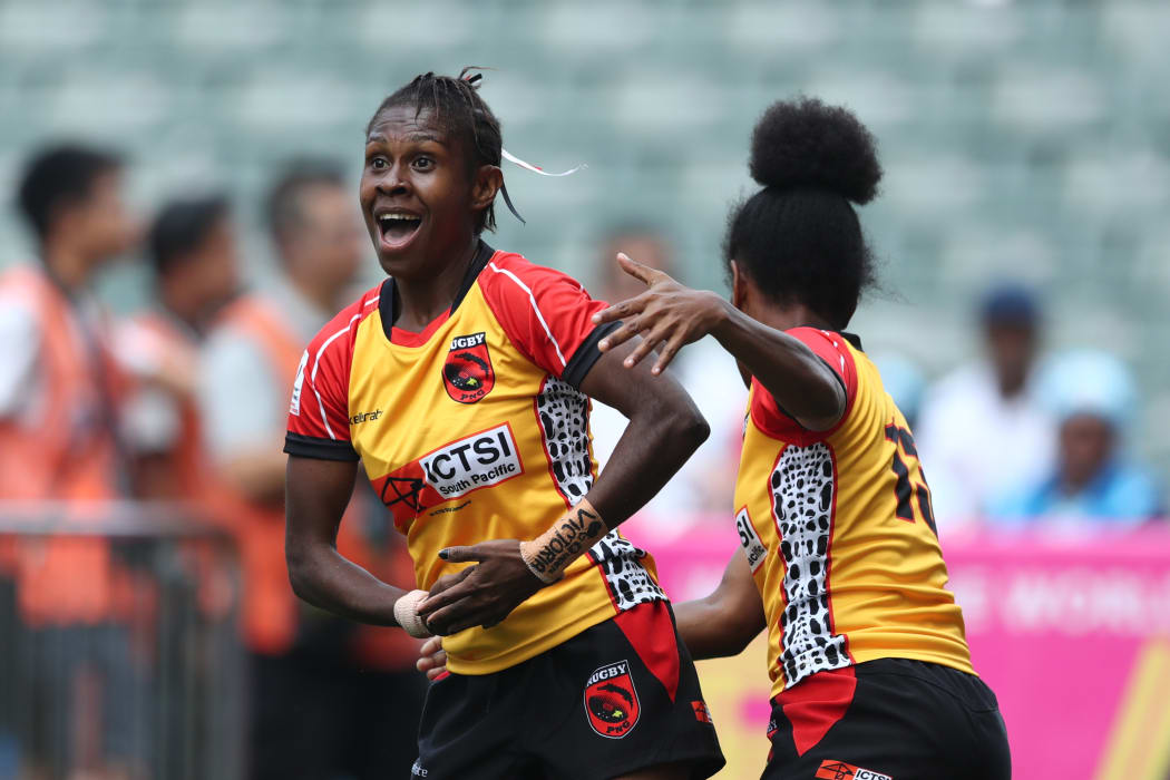 Papua New Guinea's Alice Alois celebrates a try against Scotland.