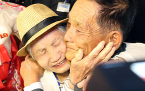 South Korean Lee Keum-seom (L), 92, meets with her North Korean son Ri Sung Chol (R), 71, during a separated family reunion meeting at the Mount Kumgang resort on the North's southeastern coast on August 20, 2018.