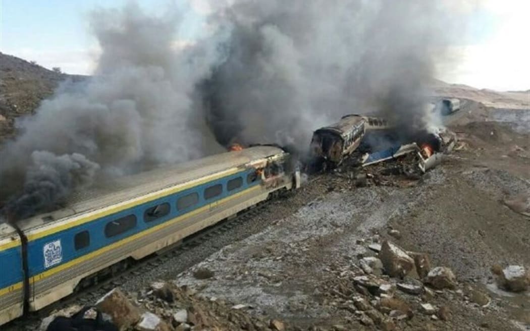 Two trains burn after a collision which killed 40 people in Iran.