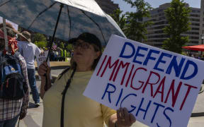 A protestor holds a sign in Washington, DC, United States, on 1 May, 2025, in a march against US President Donald Trump's administration.