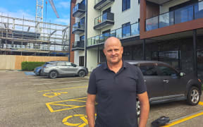 Dave Barr outside a retirement village development in Kumeū completed before Watercare constraints.