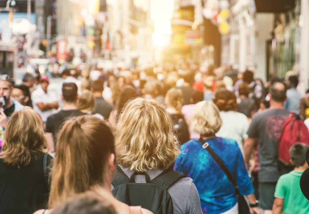 Unrecognizable mass of people walking in the city