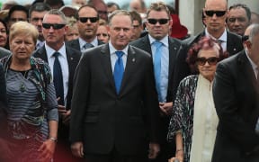 John Key is escorted onto Te Tii Marae at Waitangi by Ngapuhi kuia Titewhai Harawira (R) and Ngati Whatua leader Naida Glavish.