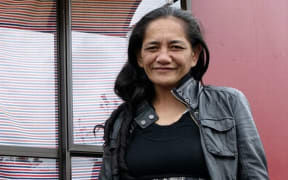 Mandy stands outside her home at Western Park Village in West Auckland.