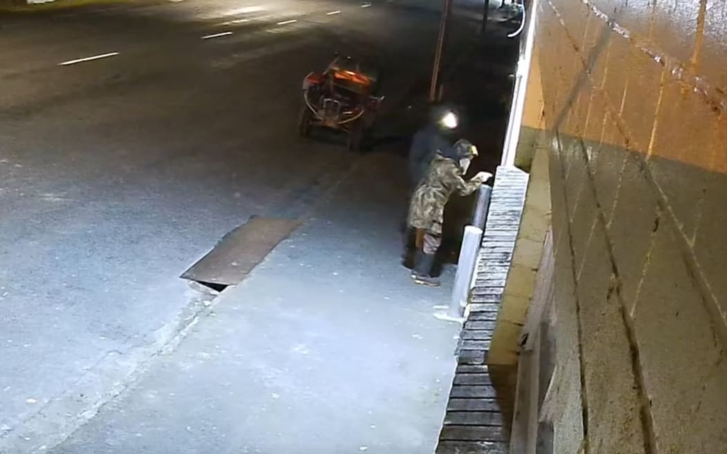 A still image from the CCTV believed to show Tom Phillips and a child.