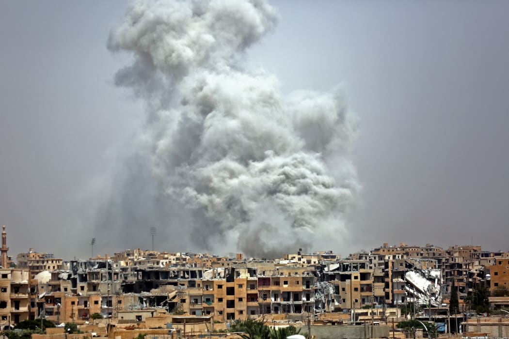 Smoke billows out from Raqqa following a US-led coalition air strike.