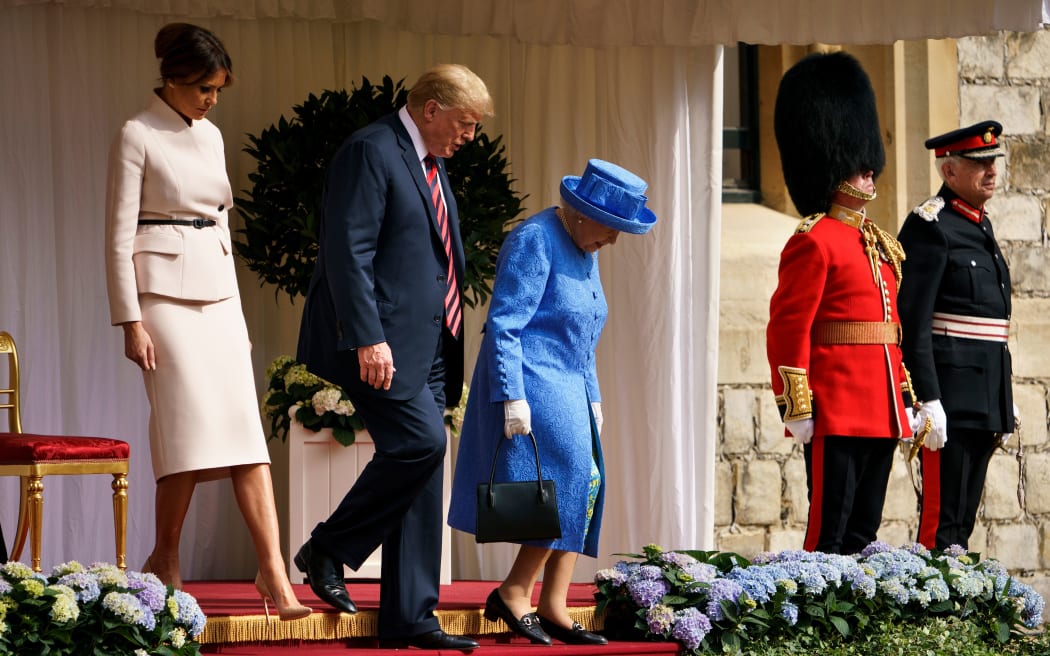 Britain's Queen Elizabeth II escorts US President Donald Trump and US First Lady Melania Trump into Windsor Castle after inspecting troops at Windsor Castle in Windsor, west of London, on the second day of Trump's UK visit.