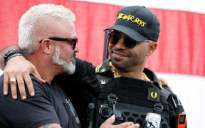 Leaders of the Proud Boys, a right-wing pro-Trump group, Enrique Tarrio (right) and Joe Biggs (left) embrace each other as the Proud boys members gather with their allies in a rally called "End Domestic Terrorism"  against Antifa in Portland, Oregon on 26 September, 2020.