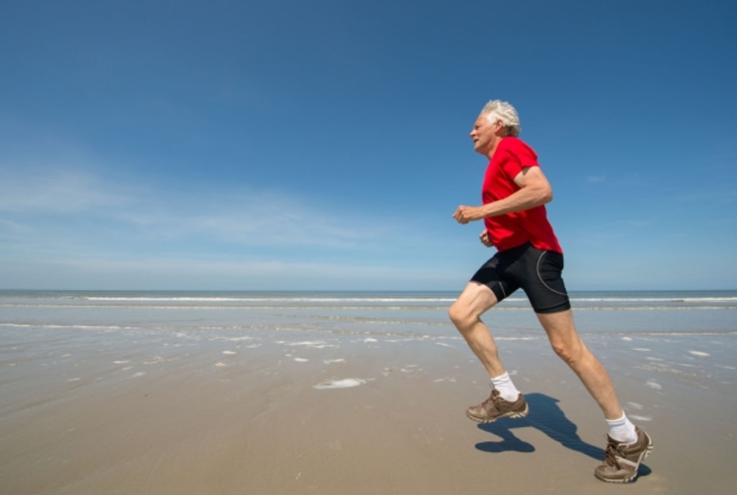 senior man running on beach