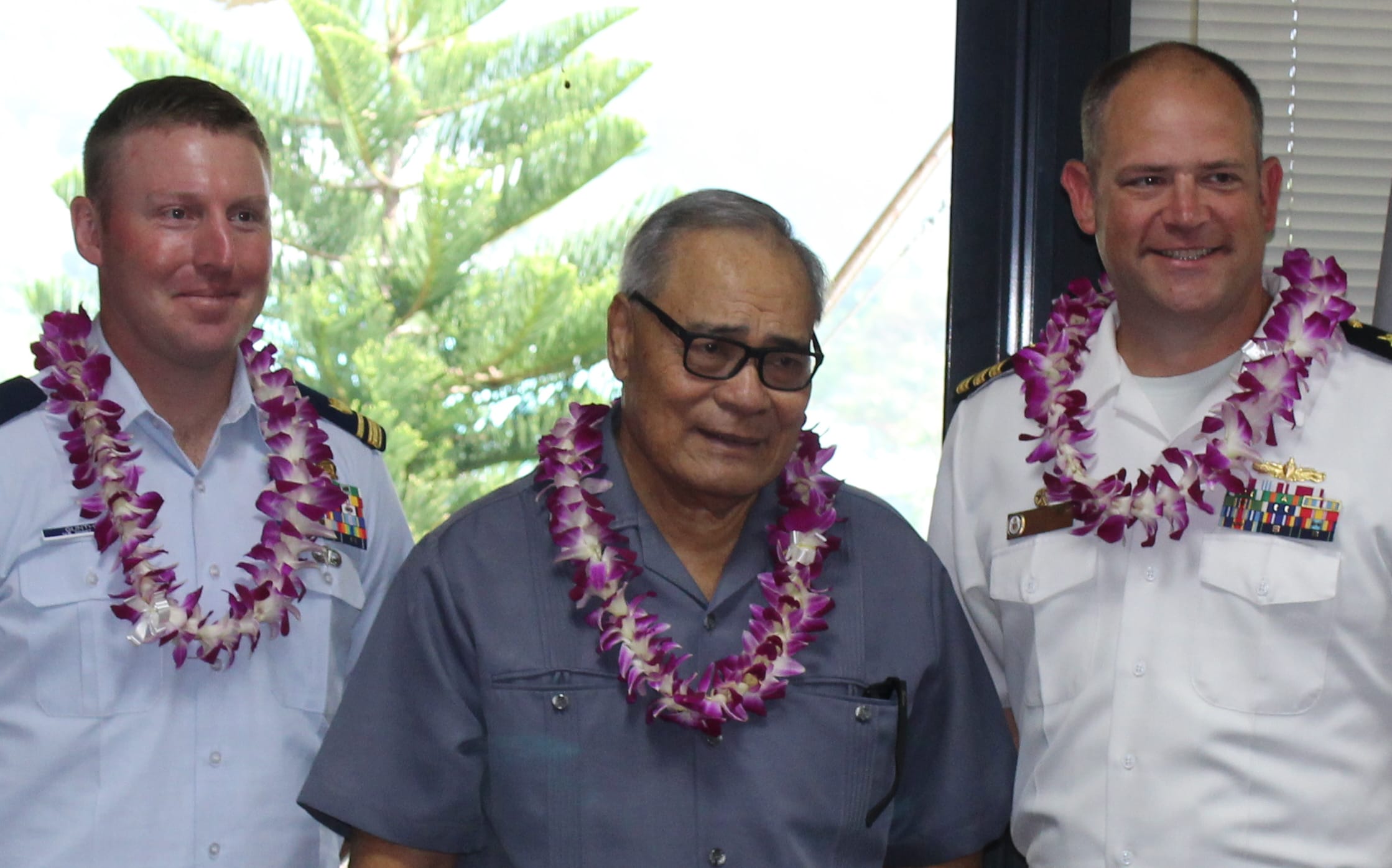 US Coast Guard official; Governor Lolo Matalasi Moliga; and  Commander Andy Strickland, Commanding Officer of the USS Shoup.