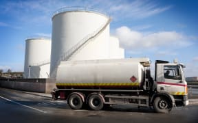 A truck with a fuel tank at an industrial storage site.