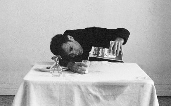 Cover image of Andrew Bird's album 'Sunday Morning Put-On'. Bird pours a glass of milk.