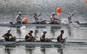 (TOP L-R) US' Nick Mead, Justin Best, Michael Grady and Liam Corrigan celebrate winning the gold medal next to New Zealand's boat in the men's four final rowing competition at Vaires-sur-Marne Nautical Centre in Vaires-sur-Marne during the Paris 2024 Olympic Games on August 1, 2024. (Photo by Olivier MORIN / AFP)
