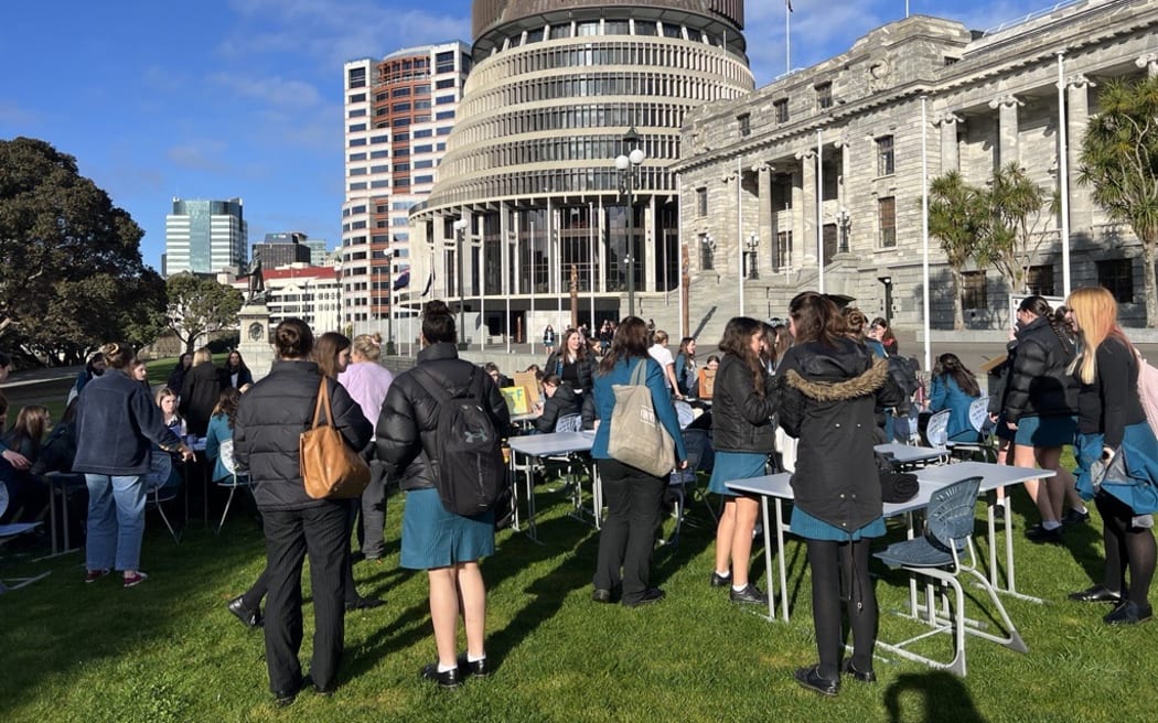 About 60 Wellington Girls' College students set up a makeshift classroom on Parliament grounds as a protest against the school having to close for two days over quake-prone buildings 14 August 2024