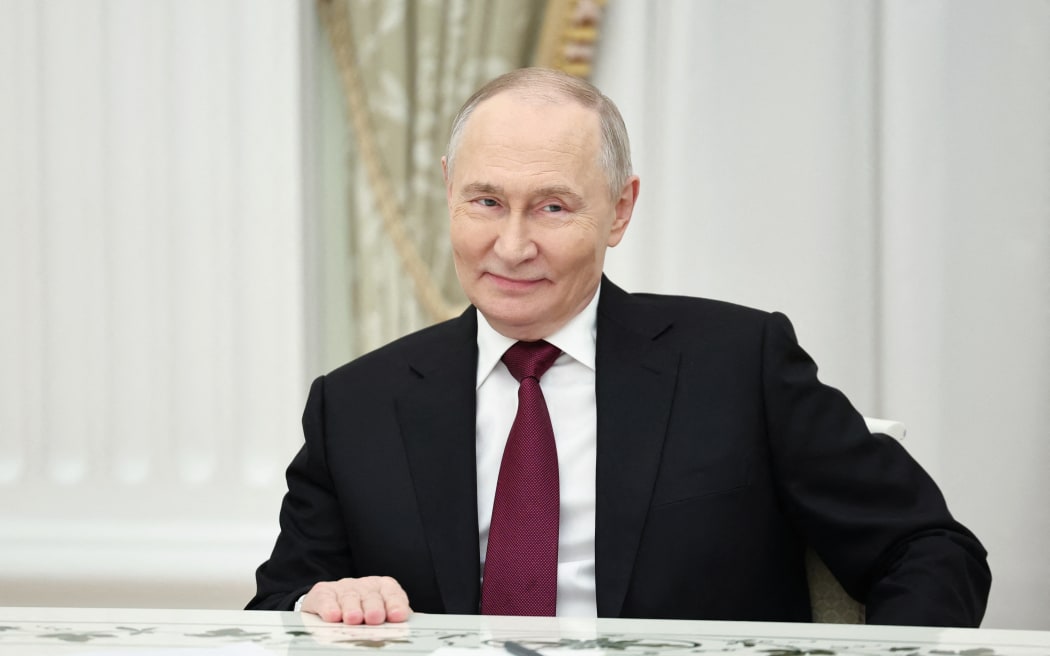 In this pool photograph distributed by the Russian state agency Sputnik, Russia's President Vladimir Putin attends a meeting with US special envoy Steve Witkoff and US President Donald Trump's son-in-law Jared Kushner (both not pictured) at the Kremlin in Moscow on December 2, 2025. (Photo by Alexander KAZAKOV / POOL / AFP)