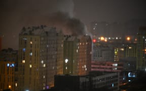 Smoke rises from a building after Russia launched an attack with drones and missiles on Kyiv on January 9, 2026, amid the Russian invasion of Ukraine. Russian strikes on Ukraine's capital and its suburbs killed at least three people, Kyiv's mayor said Friday, as the air force issued a countrywide missile warning. The attack on Kyiv ignited fires and damaged apartment buildings, with "three dead and 13 wounded," according to Mayor Vitali Klitschko. (Photo by Eugene KOTENKO / AFP)