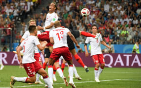 Mathias Jorgensen of Denmark heads the ball clear in front of Dejan Lovren of Croatia.
