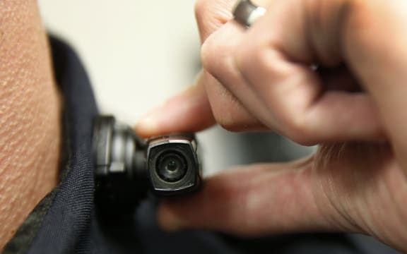 WEST VALLEY CITY, UT - MARCH 2: A West Valley City police officer shows off a newly-deployed body camera attached to his shirt collar on March 2, 2015 in West Valley City, Utah. West Valley City Police Department has issued 190 Taser Axon Flex body cameras for all it's sworn officers to wear starting today.   George Frey/Getty Images/AFP (Photo by GEORGE FREY / GETTY IMAGES NORTH AMERICA / Getty Images via AFP)