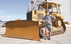 Hamish Pryde with the bulldozer that he has owned for about 30 years. The machine started its life in Fiji before being imported to New Zealand.
