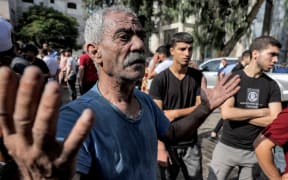 EDITORS NOTE: Graphic content / A man reacts outside the morgue of al-Shifa hospital in Gaza City on October 12, 2023. Thousands of people, both Israeli and Palestinians have died since October 7, 2023, after Palestinian Hamas militants based in the Gaza Strip, entered southern Israel in a surprise attack leading Israel to declare war on Hamas in Gaza on October 8. (Photo by MOHAMMED ABED / AFP)