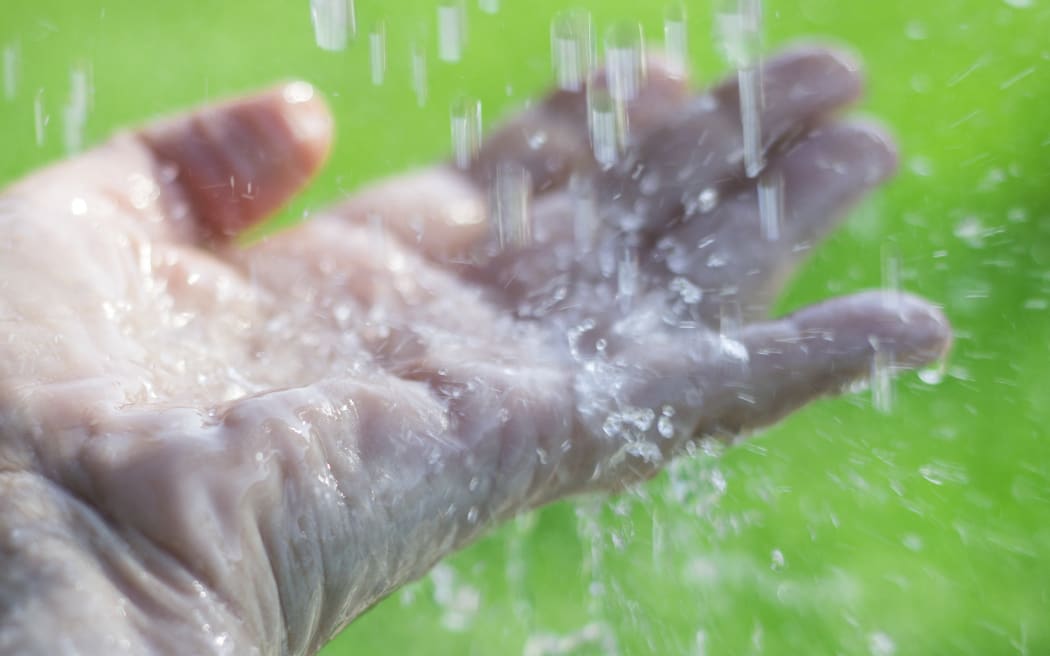 Water splashing on an outstretched hand. (Photo by CRISTINA PEDRAZZINI/SCIENCE PHOT / CPD / Science Photo Library via AFP)