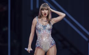 Taylor Swift performs on stage as part of her Eras Tour, 2024.