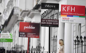 Estate Agents' "For Sale", "Sold", and " To-Let" boards are pictured outside residential properties in south London.