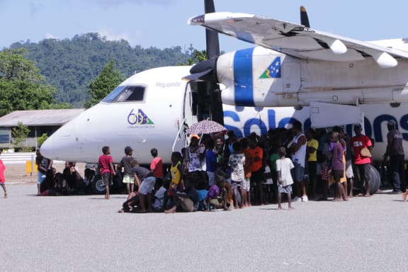 Seghe community escapes the heat at the new runway opening ceremony.
