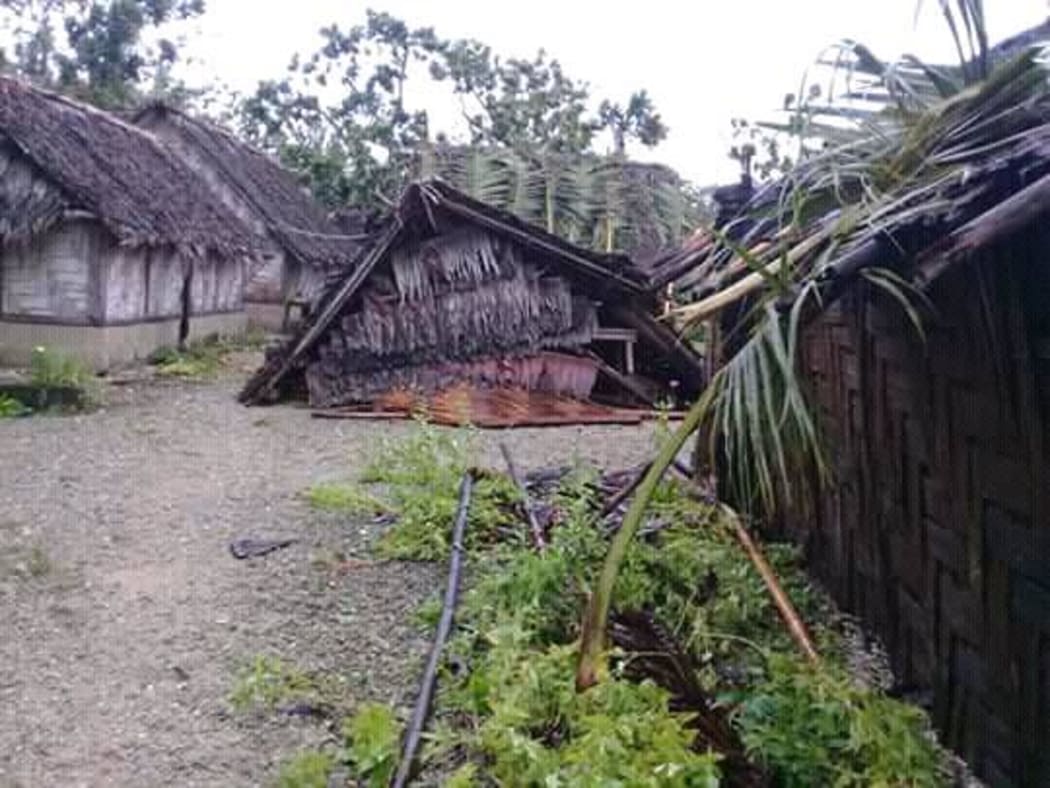 A damaged house, fallen trees and damaged gardens on Uripiv, a low-lying island close to Malekula.