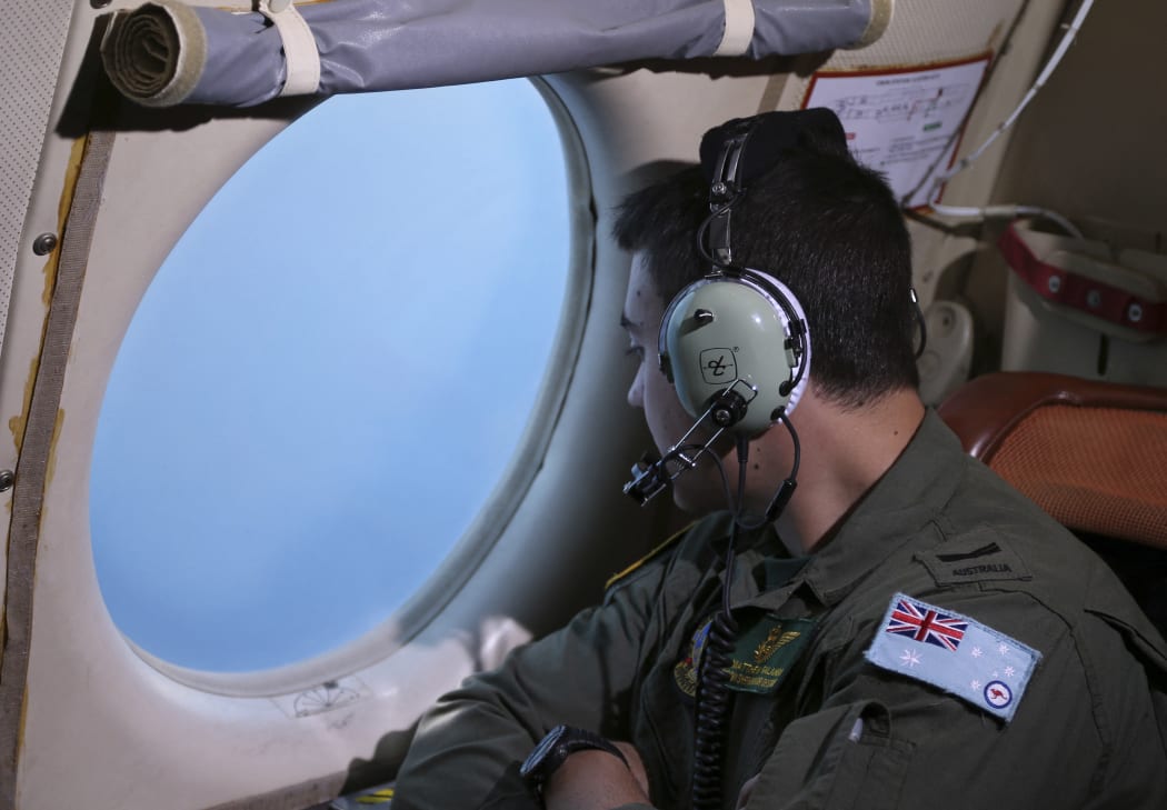 Sargent Matthew Falanga, on board a Royal Australian Air Force AP-3C Orion, scans for debris or wreckage of missing Malaysia Airlines flight MH370 in the southern Indian Ocean on 22 March 2014.
