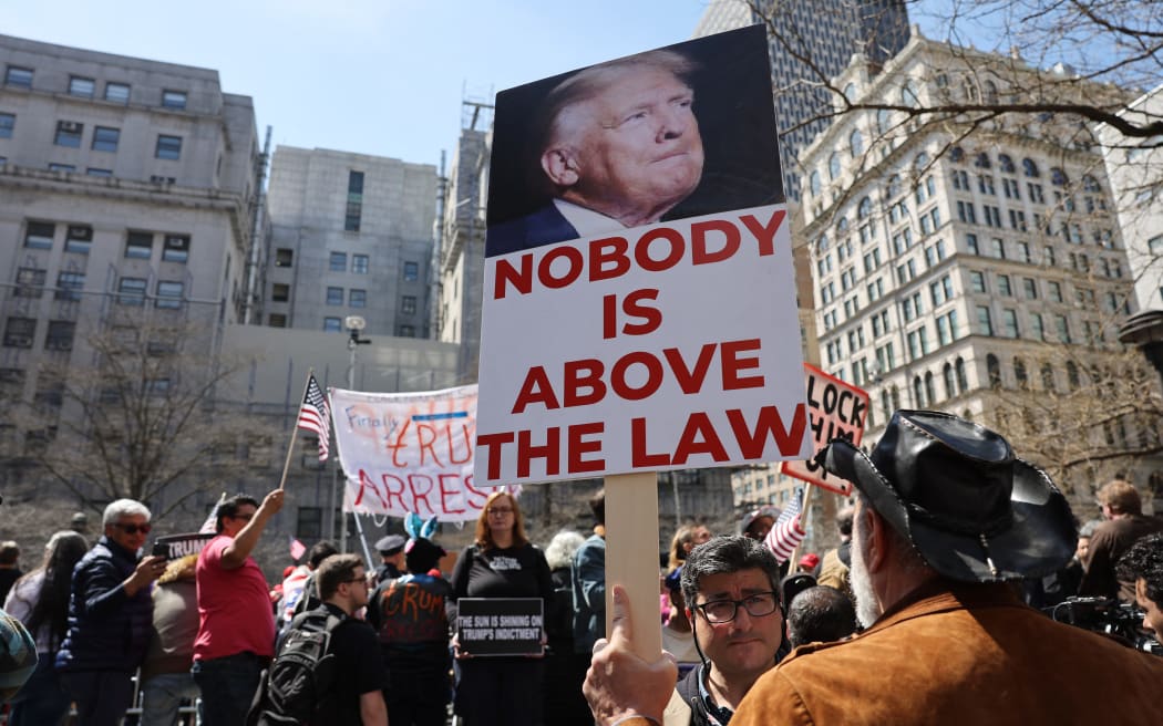 People protesting against former President Donald Trump gather outside of the Manhattan Criminal Court before his arraignment on 4 April, 2023 in New York City.