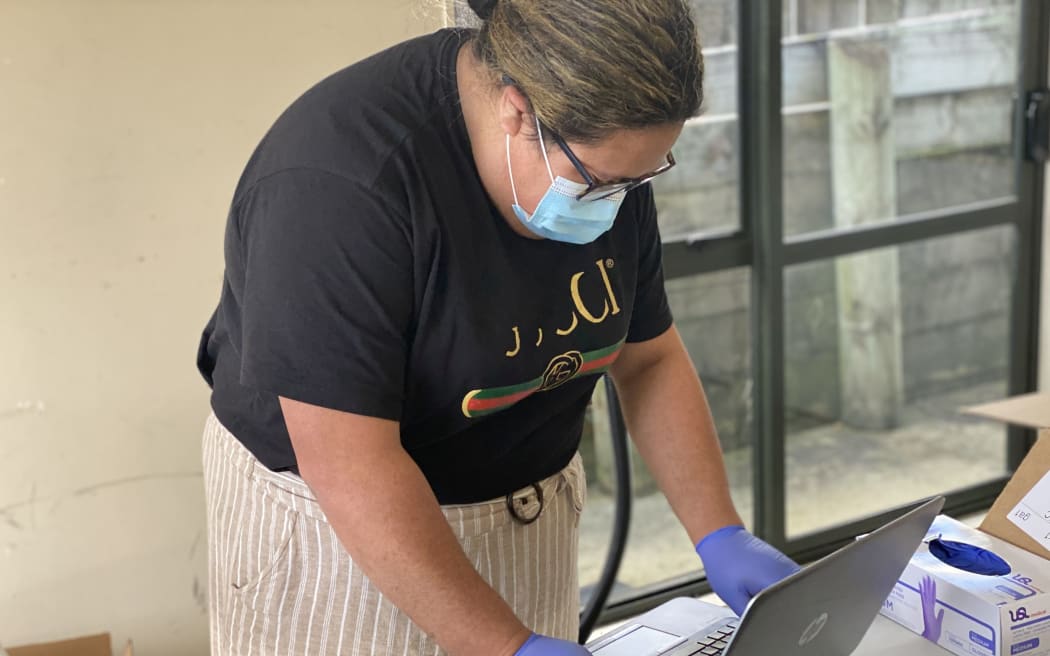 Preparing laptops to go out to Pasifika students