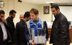 Iranian billionaire tycoon Babak Zanjani, centre, in a court in Tehran, Iran.