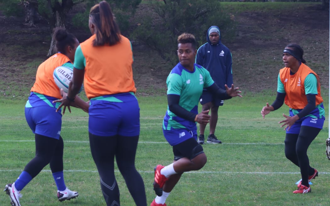 A photo of Fijiana Drua players passing the ball at a training session