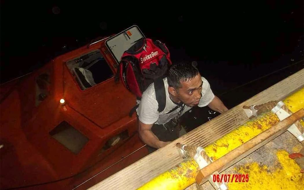 This handout picture provided by the UAE Ministry of Foreign Affairs reportedly shows members of the Greek owned, Liberian-flagged Magic Seas commercial vessel climbing on board the Safeen Prism, after being rescued following an attack that forced them to abandon ship, in the Red Sea on July 6, 2025. Yemen's Huthi rebels claimed responsibility on July 7 for an attack that damaged a commercial vessel in the Red Sea and forced its crew to abandon ship, their first such strike in months. The Iran-backed rebels said they hit the Magic Seas with missiles, drones and uncrewed boats because it had previously docked in Israel. (Photo by UAE's Ministry of Foreign Affairs and International Cooperation / AFP) / RESTRICTED TO EDITORIAL USE - MANDATORY CREDIT "AFP PHOTO /  UAE MINISTRY OF FOREIGN AFFAIRS / HANDOUT" - NO MARKETING NO ADVERTISING CAMPAIGNS - DISTRIBUTED AS A SERVICE TO CLIENTS
