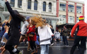 Protesters dance in the middle of Auckland's Custom Street.