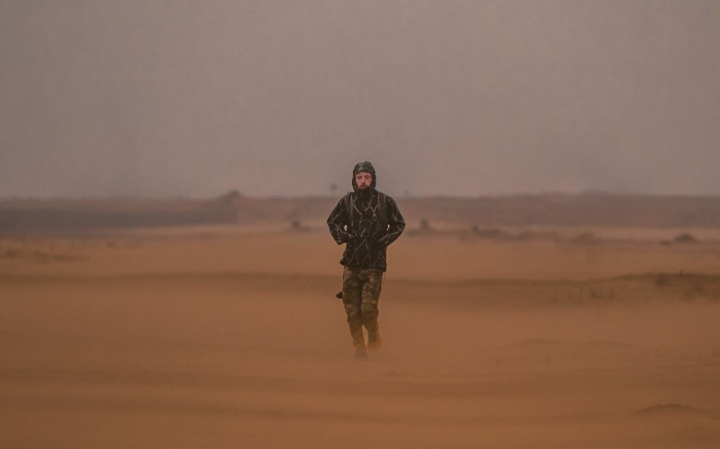 Russell Cook runs across the Sahara Desert.