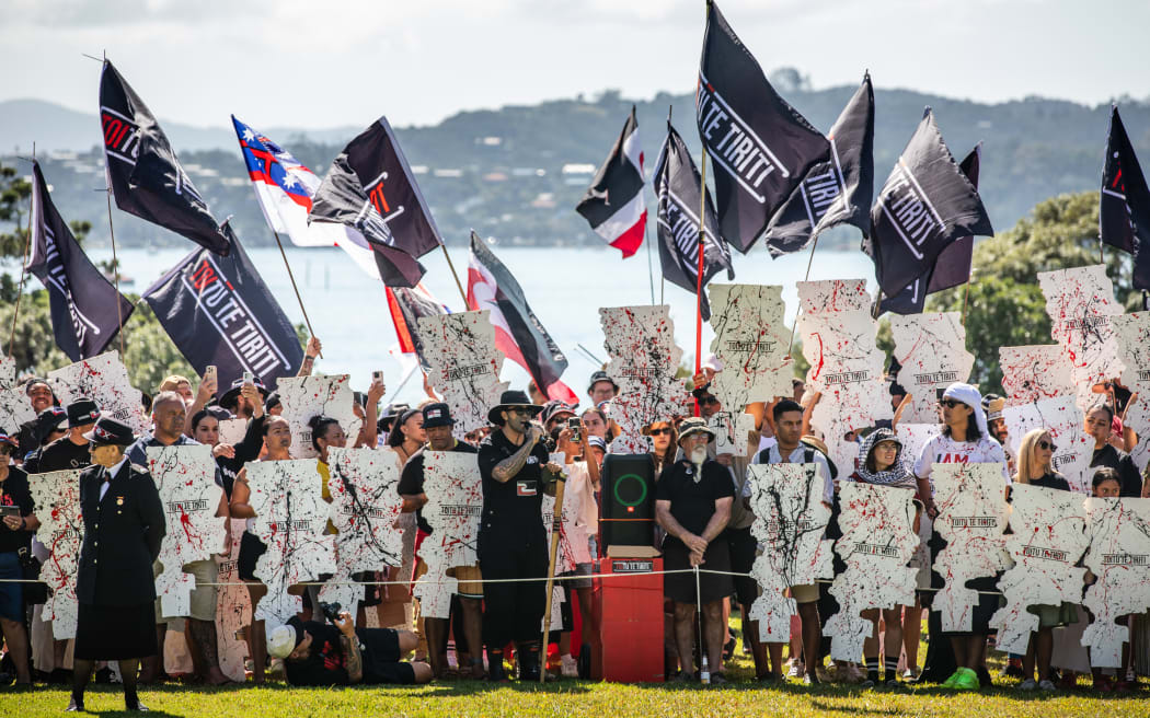 Eru Kapa-King speaks to the crowds as Toitū Te Tiriti stage a walk out ahead of the Parliamentary Powhiri at the Waitangi Treaty grounds, Wednesday 5 Februray.