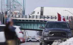 A tractor trailer drives on the US bound lanes of the Ambassador Bridge border crossing, in Windsor, Ontario, on February 8, 2022.