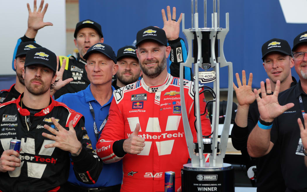 New Zealand driver Shane Van Gisbergen celebrates a NASCAR win with his team.