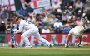 Ollie Pope attempts a run out as Glenn Phillips dives during the first cricket test between New Zealand and England at Hagley Oval in Christchurch, Nov 2024.