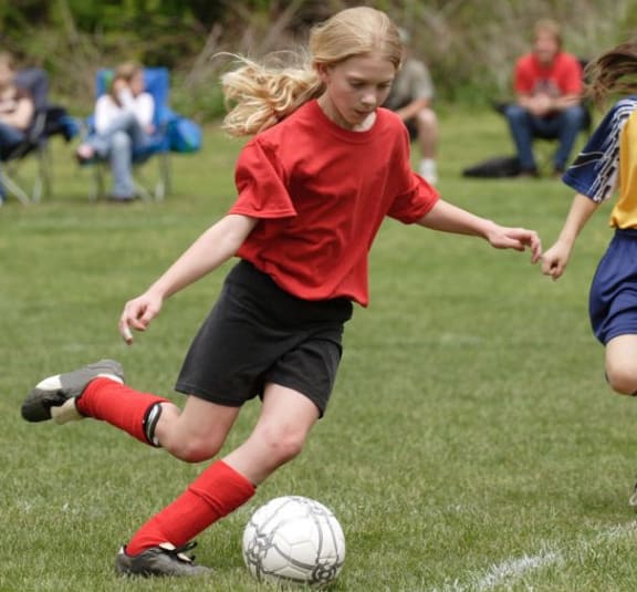 Young girl plays soccer