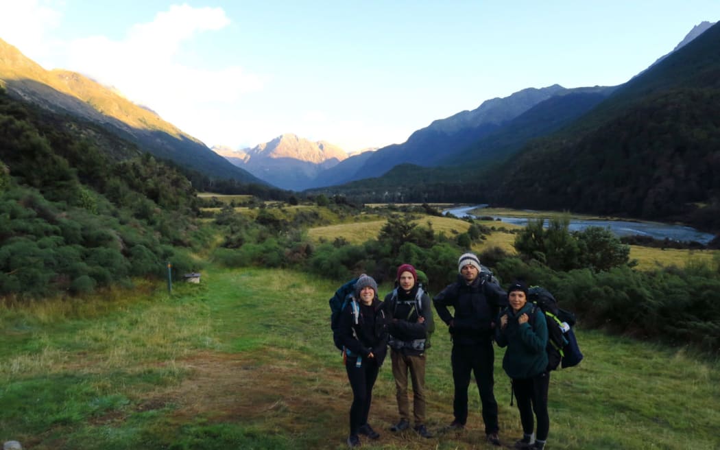 Pauline Dupont and Romain (left) and friends tramping in New Zealand. They emerged from the bush to find the world had turned upside down.