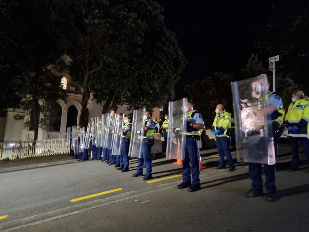 Police hold riot shields after a stand-off with protesters on Hill Street, near Parliament, on 23 February, 2022.